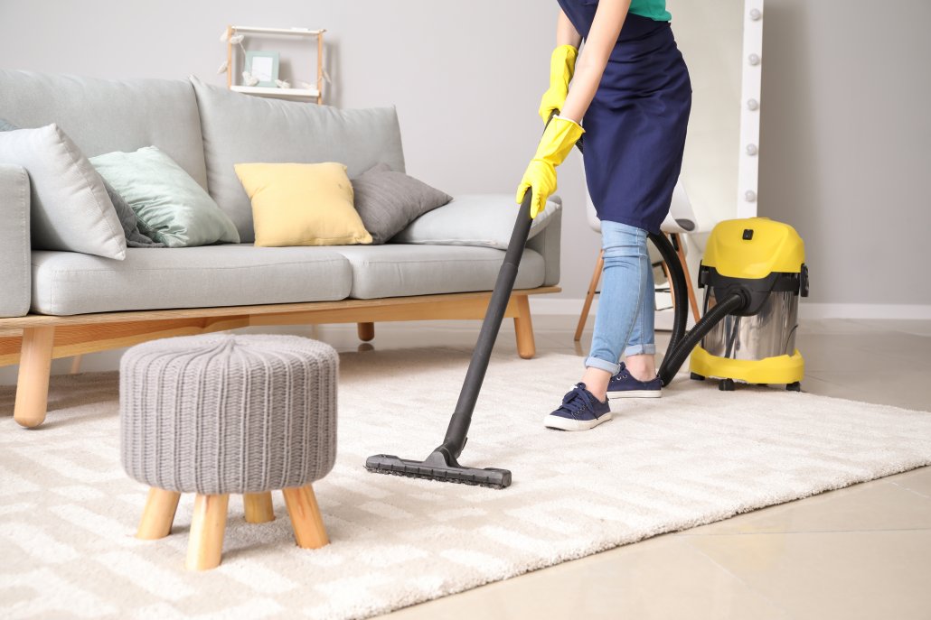 Woman cleaning home with vacuum 